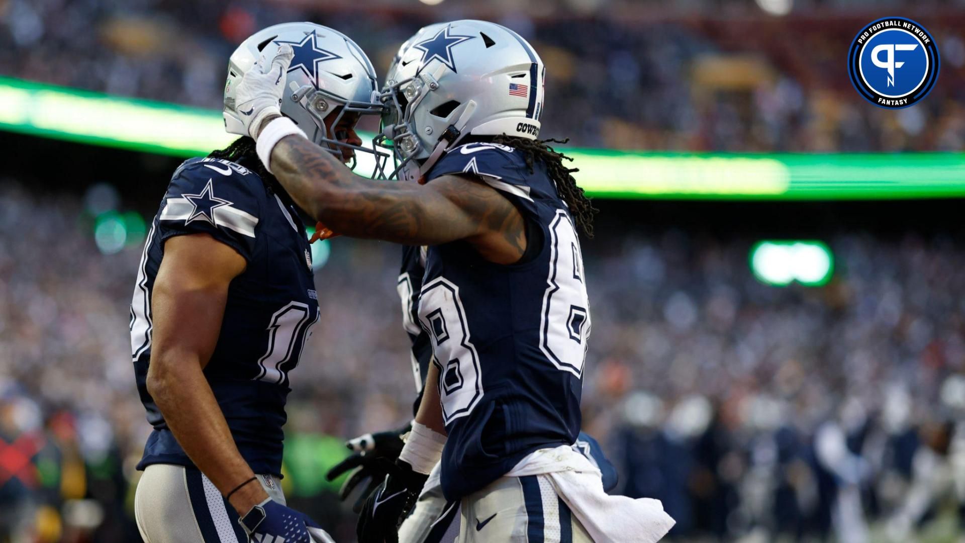 Dallas Cowboys wide receiver Jalen Tolbert (18) celebrates with Cowboys wide receiver CeeDee Lamb (88) after catching a touchdown pass against the Washington Commanders during the first quarter at FedExField.