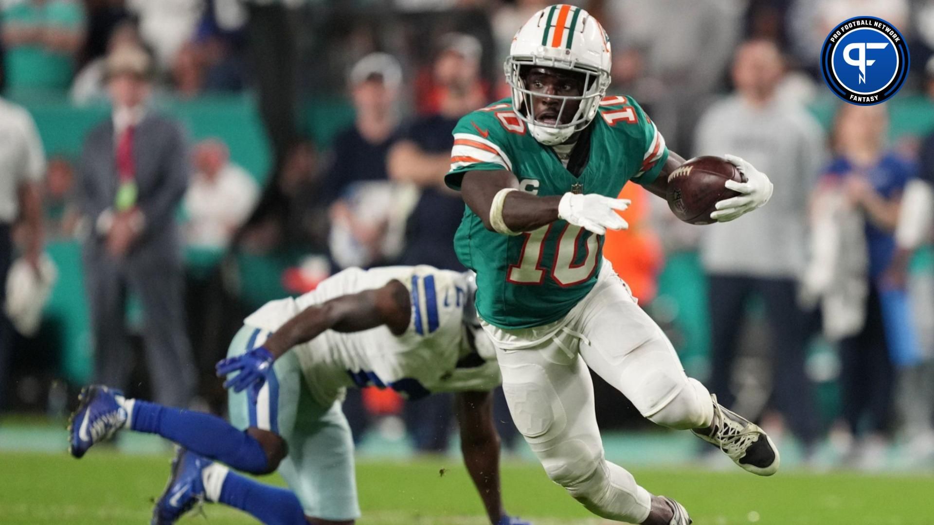 Miami Dolphins wide receiver Tyreek Hill (10) picks up a first down on the Dolphins final drive that lead to a game-winning field goal against the Dallas Cowboys during an NFL game at Hard Rock Stadium in Miami Gardens, Dec. 24, 2023.