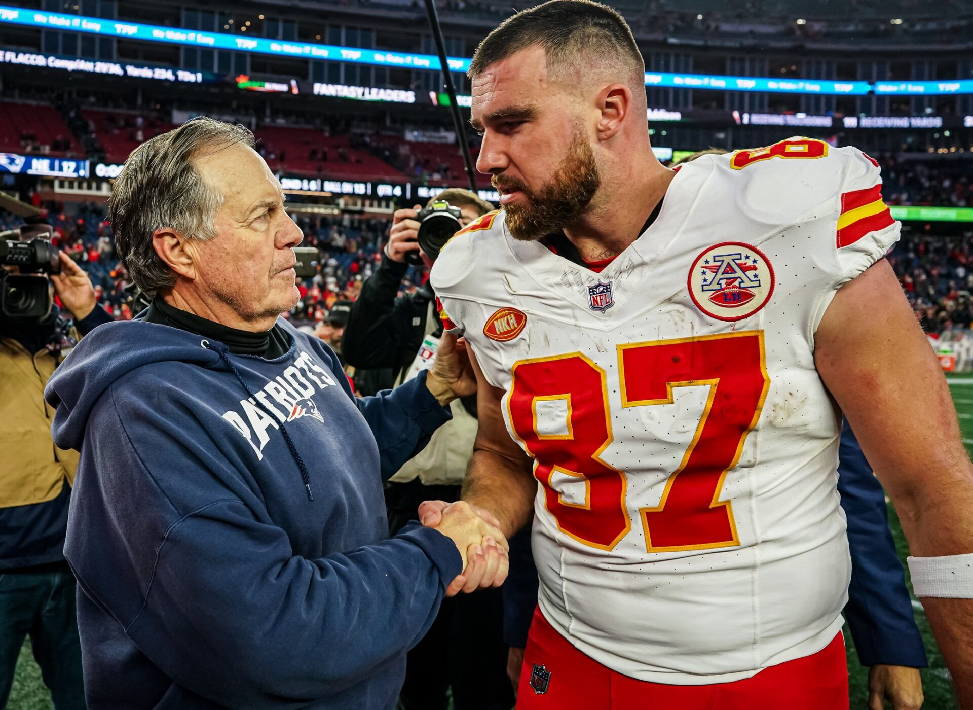 New England Patriots head coach Bill Belichick and Kansas City Chiefs tight end Travis Kelce (87) on the field after the game at Gillette Stadium.