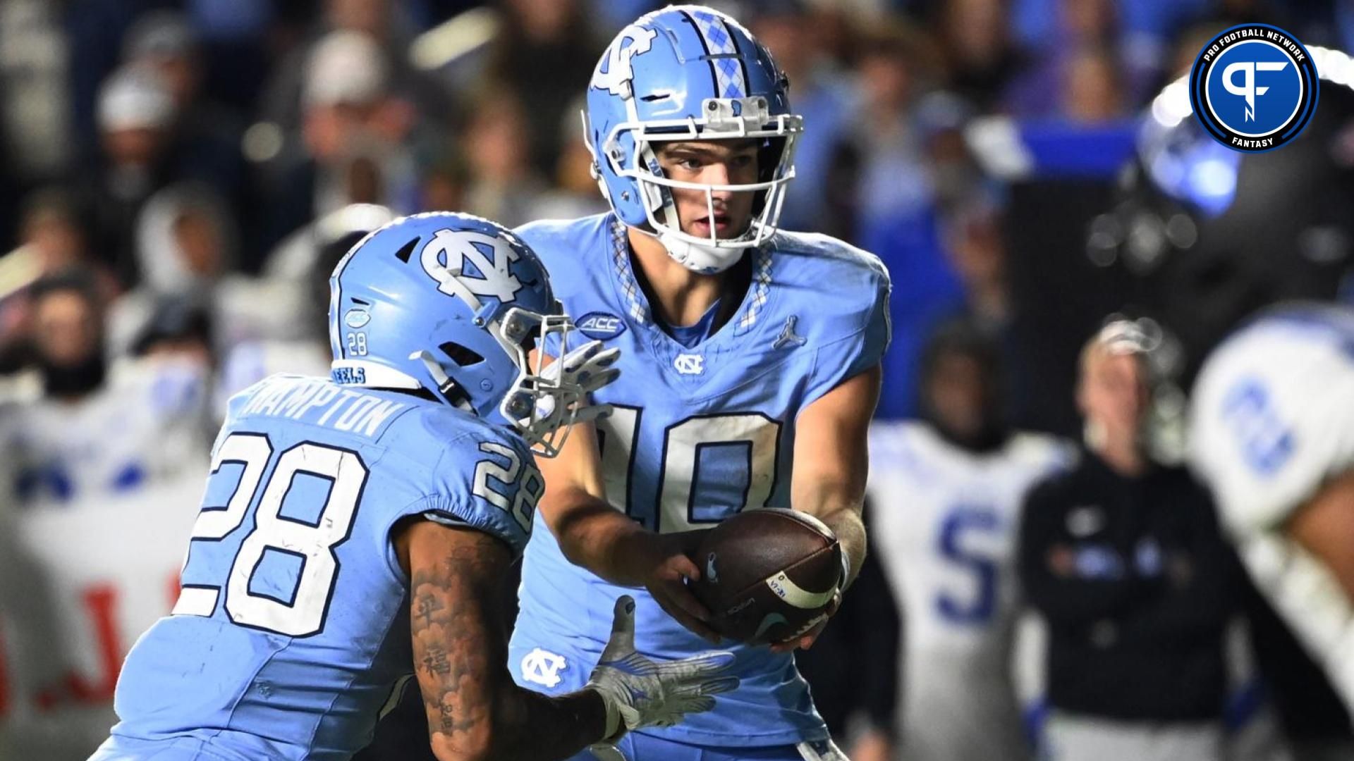 North Carolina Tar Heels quarterback Drake Maye (10) hands the ball off to running back Omarion Hampton (28) in the fourth quarter at Kenan Memorial Stadium.