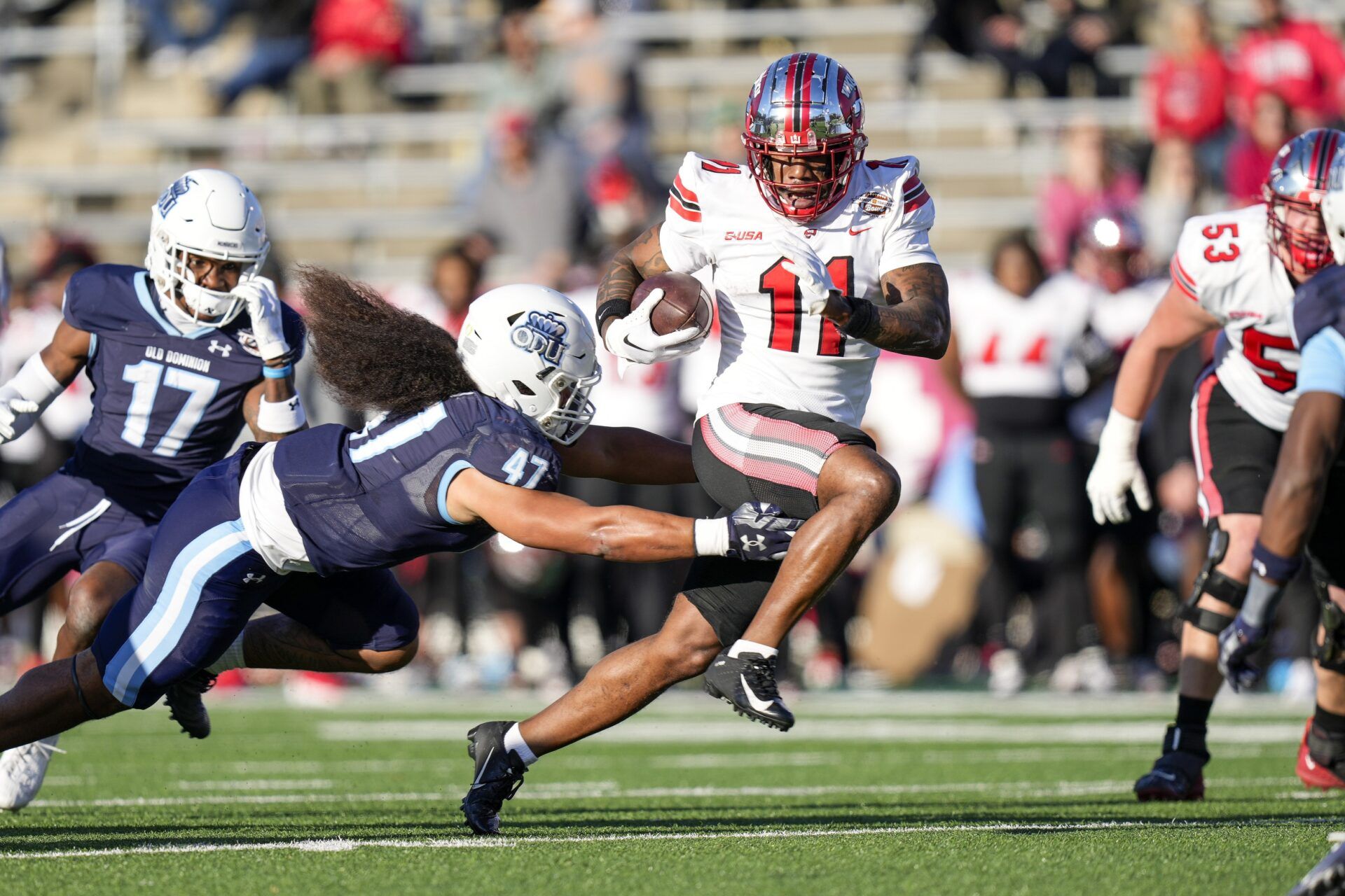 Western Kentucky Hilltoppers wide receiver Malachi Corley (11) runs the ball against Old Dominion Monarchs linebacker Koa Naotala (47) during the first quarter at Charlotte 49ers' Jerry Richardson Stadium.