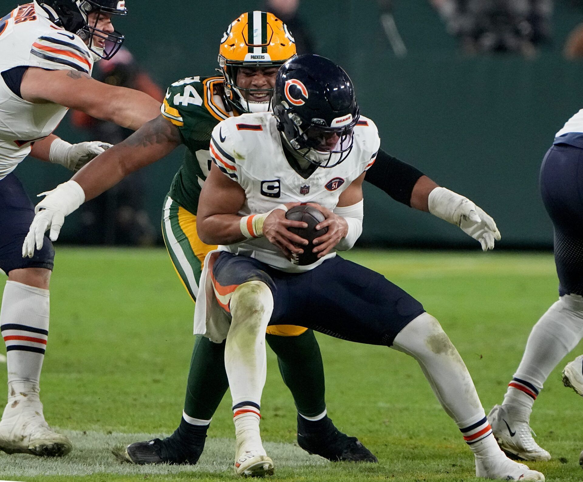 Green Bay Packers defensive end Karl Brooks (94) sacks Chicago Bears quarterback Justin Fields (1) during the fourth quarter of their game.