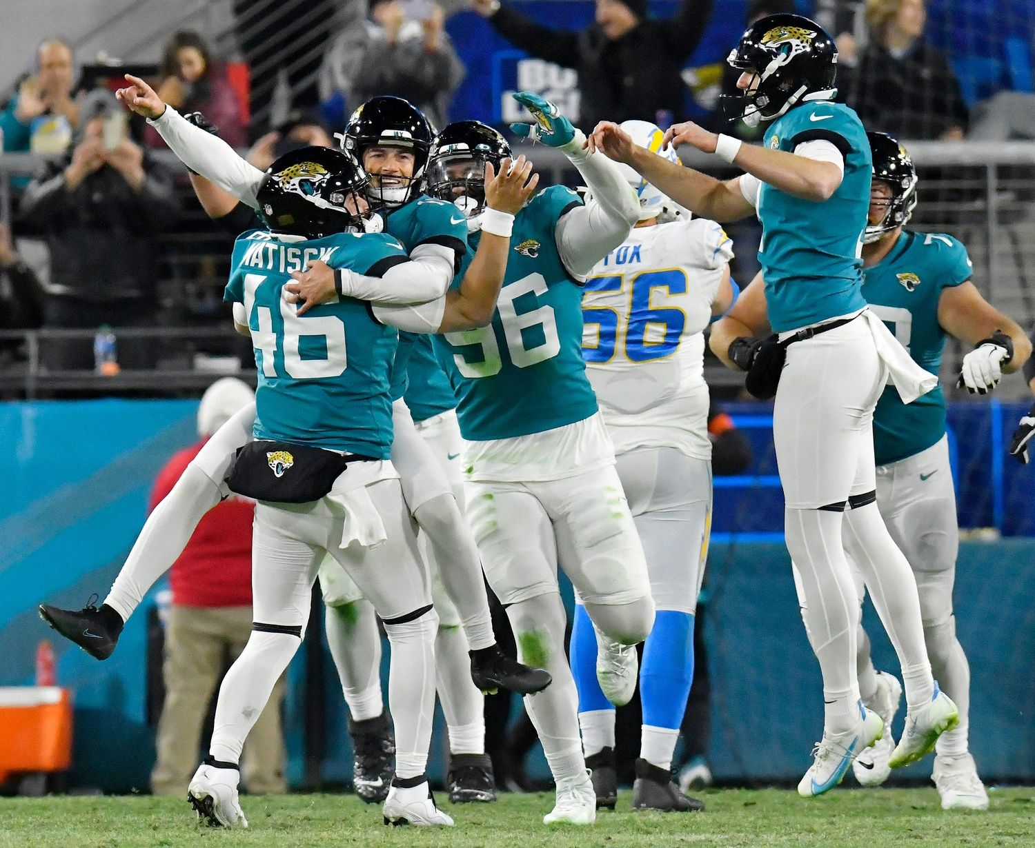 Jacksonville Jaguars place kicker Riley Patterson (10) jumps into the arms of long snapper Ross Matiscik (46) after he kicked the game-winning field goal against the Chargers. The Jacksonville Jaguars hosted the Los Angeles Chargers in their first-round playoff game Saturday, January 14, 2023, at TIAA Bank Field in Jacksonville, Fla. The Jaguars trailed 27 to 7 at the half but came back to win the game 31 to 30