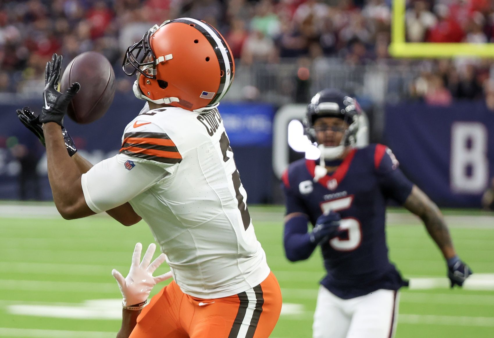 Cleveland Browns wide receiver Amari Cooper (2) catches a touchdown pass with Houston Texans safety Jalen Pitre (5) chasing in the second quarter at NRG Stadium.