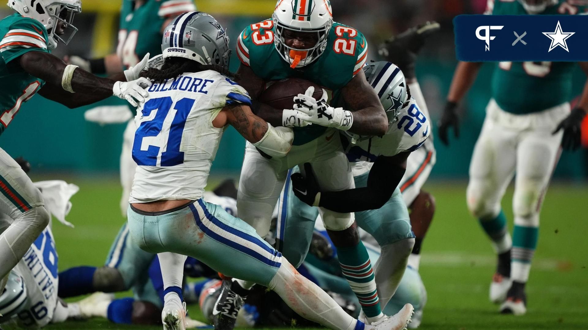 Dallas Cowboys CB Stephon Gilmore (21) tackles Miami Dolphins RB Jeff Wilson Jr. (23).