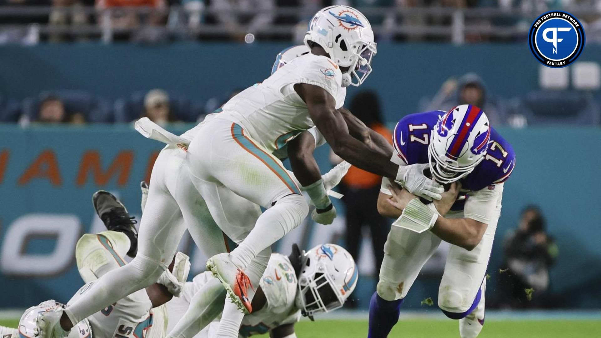 Buffalo Bills quarterback Josh Allen (17) runs with the football against Miami Dolphins cornerback Kader Kohou (4) during the fourth quarter at Hard Rock Stadium.