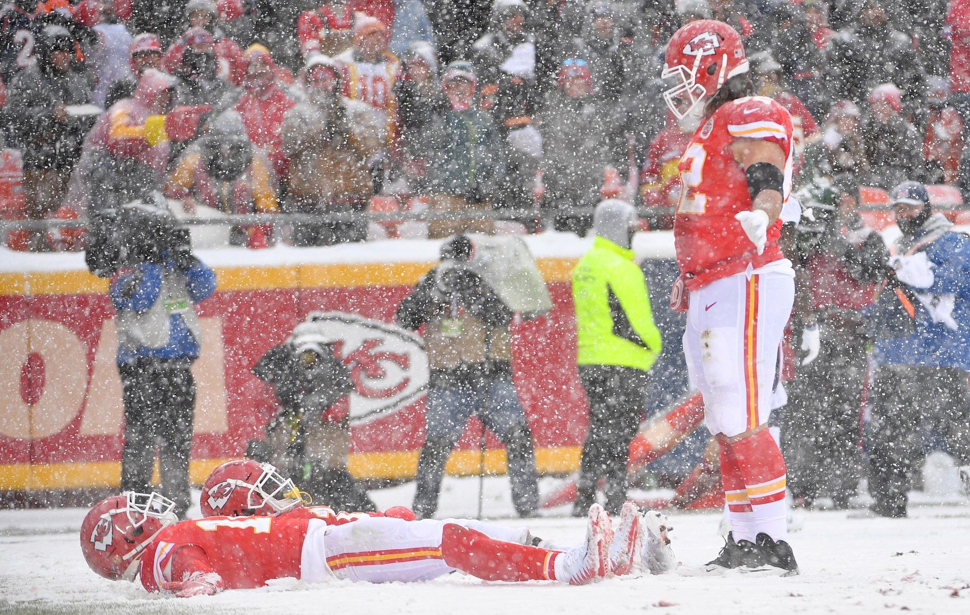 Kansas City Chiefs wide receiver Tyreek Hill (10) and wide receiver Sammy Watkins (14) celebrate by making snow angles after a score during the game against the Denver Broncos at Arrowhead Stadium.