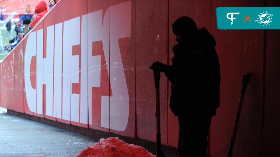 A worker clears snow from the tunnel before the game between the Kansas City Chiefs and Indianapolis Colts at Arrowhead Stadium.