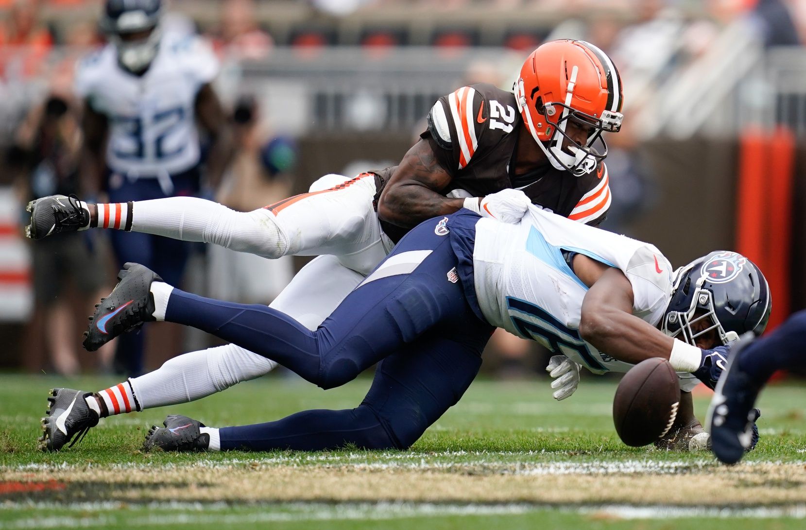 Cleveland Browns cornerback Denzel Ward (21) breaks up a pass intended for Tennessee Titans wide receiver Treylon Burks (16) during the second quarter at Cleveland Browns Stadium.