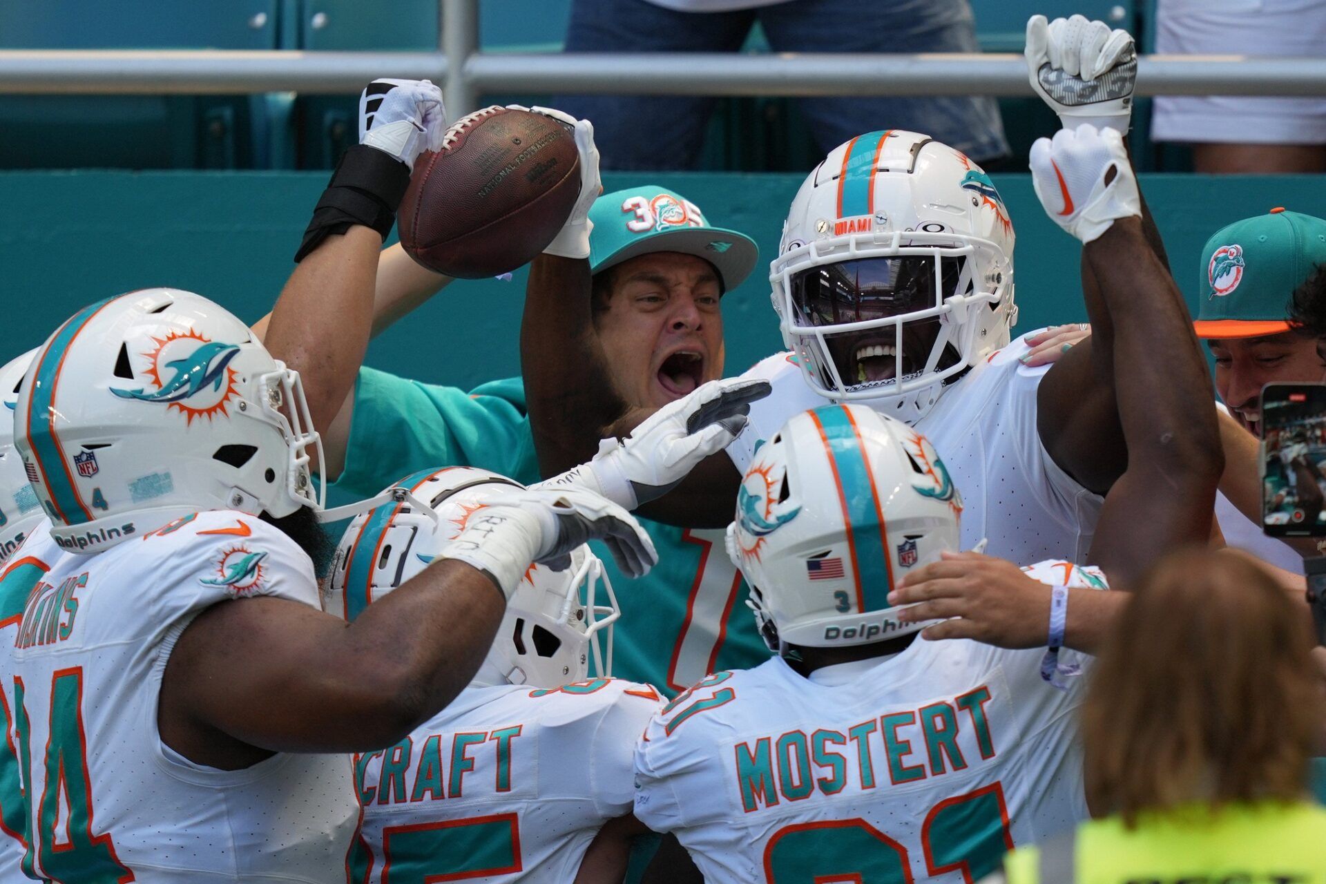 Miami Dolphins wide receiver Tyreek Hill (10) celebrates scoring a touchdown against the Denver Broncos during the first half of an NFL game from the stands at Hard Rock Stadium.