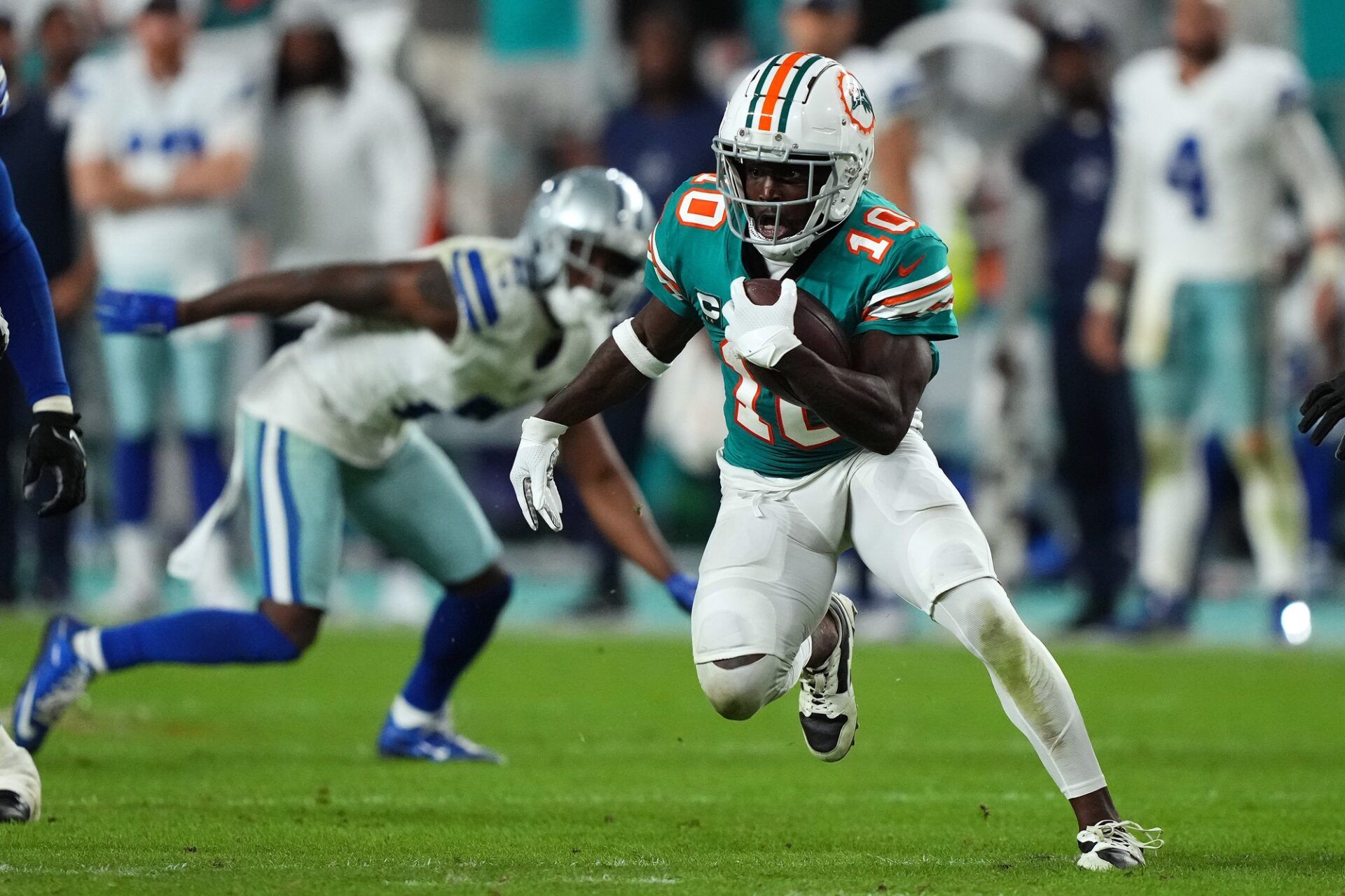 Miami Dolphins wide receiver Tyreek Hill (10) runs with the ball after a catch during the second half against the Dallas Cowboys at Hard Rock Stadium.