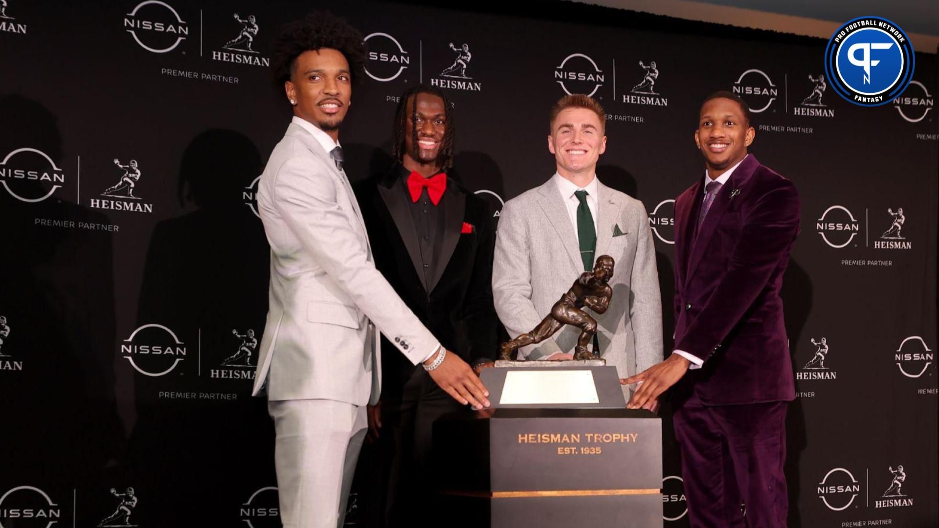 Heisman hopefuls (left to right) LSU Tigers quarterback Jayden Daniels and Ohio State Buckeyes wide receiver Marvin Harrison Jr. and Oregon Ducks quarterback Bo Nix and Washington Huskies quarterback Michael Penix Jr. pose with the Heisman trophy during a press conference in the Astor ballroom at the New York Marriott Marquis before the presentation of the Heisman trophy.