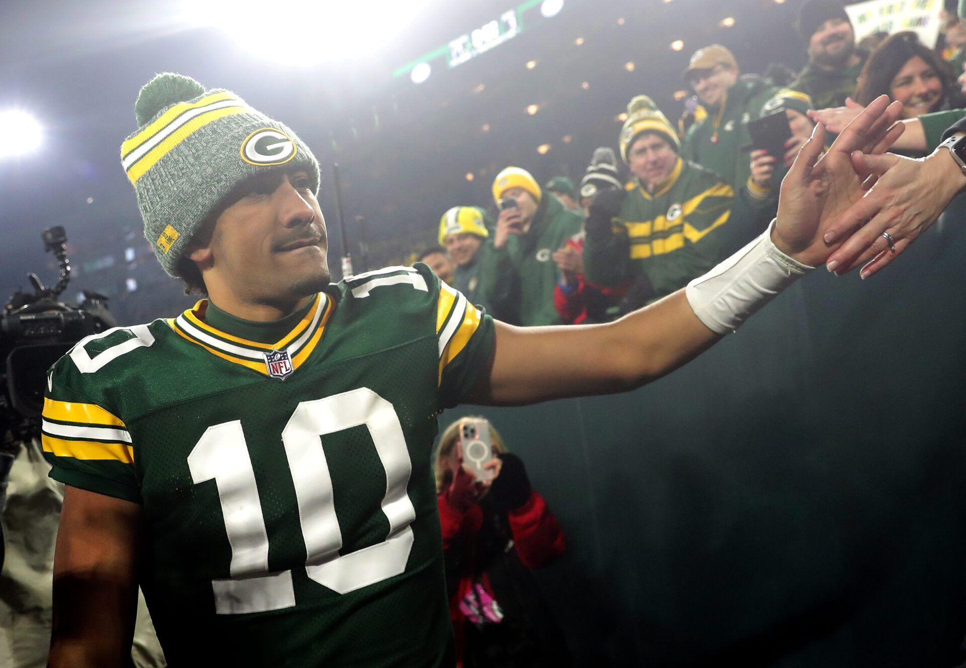 Green Bay Packers quarterback Jordan Love (10) shakes hands with fans following the Packers victory over the Chicago Bears during their football game