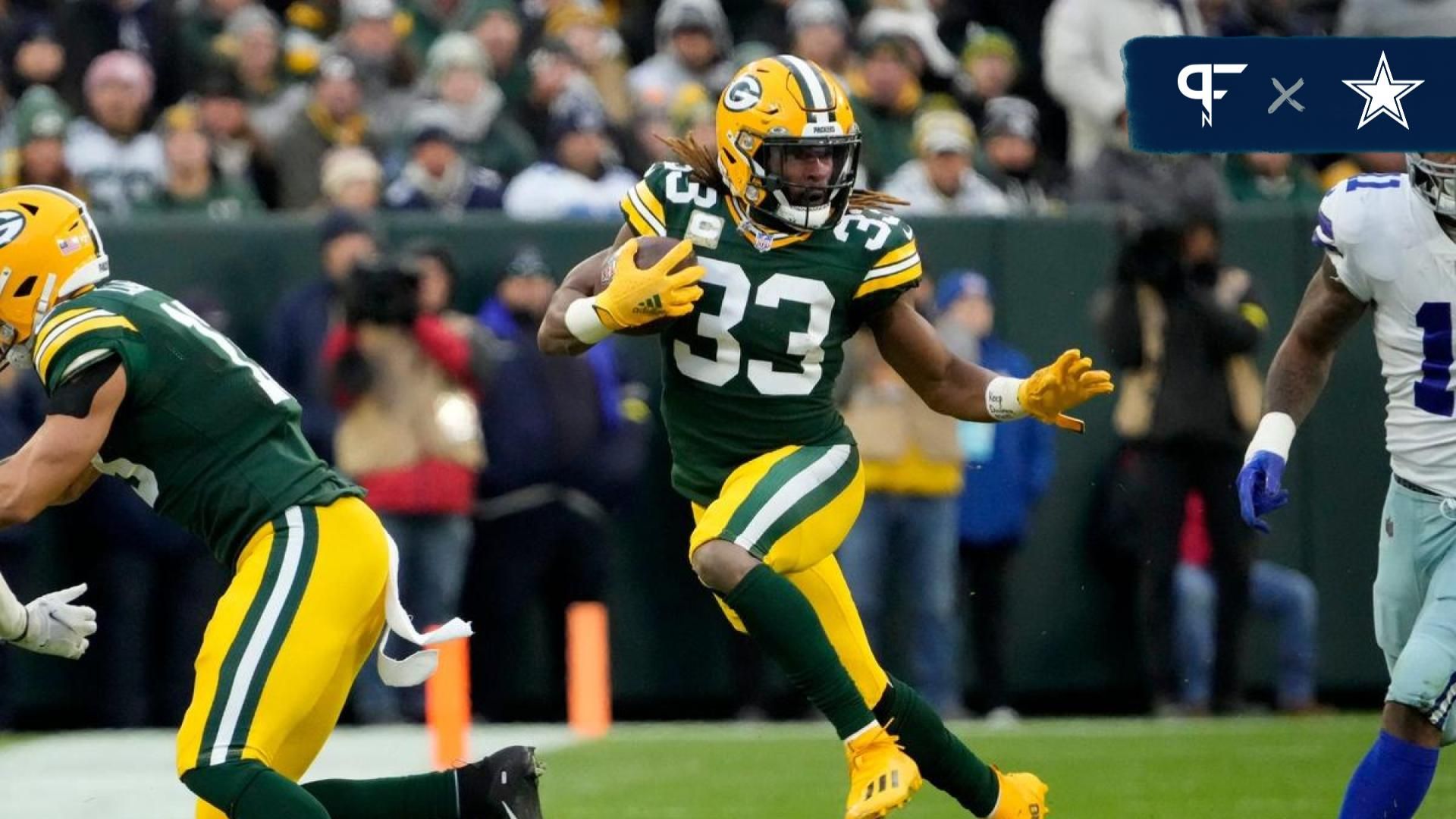 Green Bay Packers running back Aaron Jones (33) runs for a gain during the first half of their game.