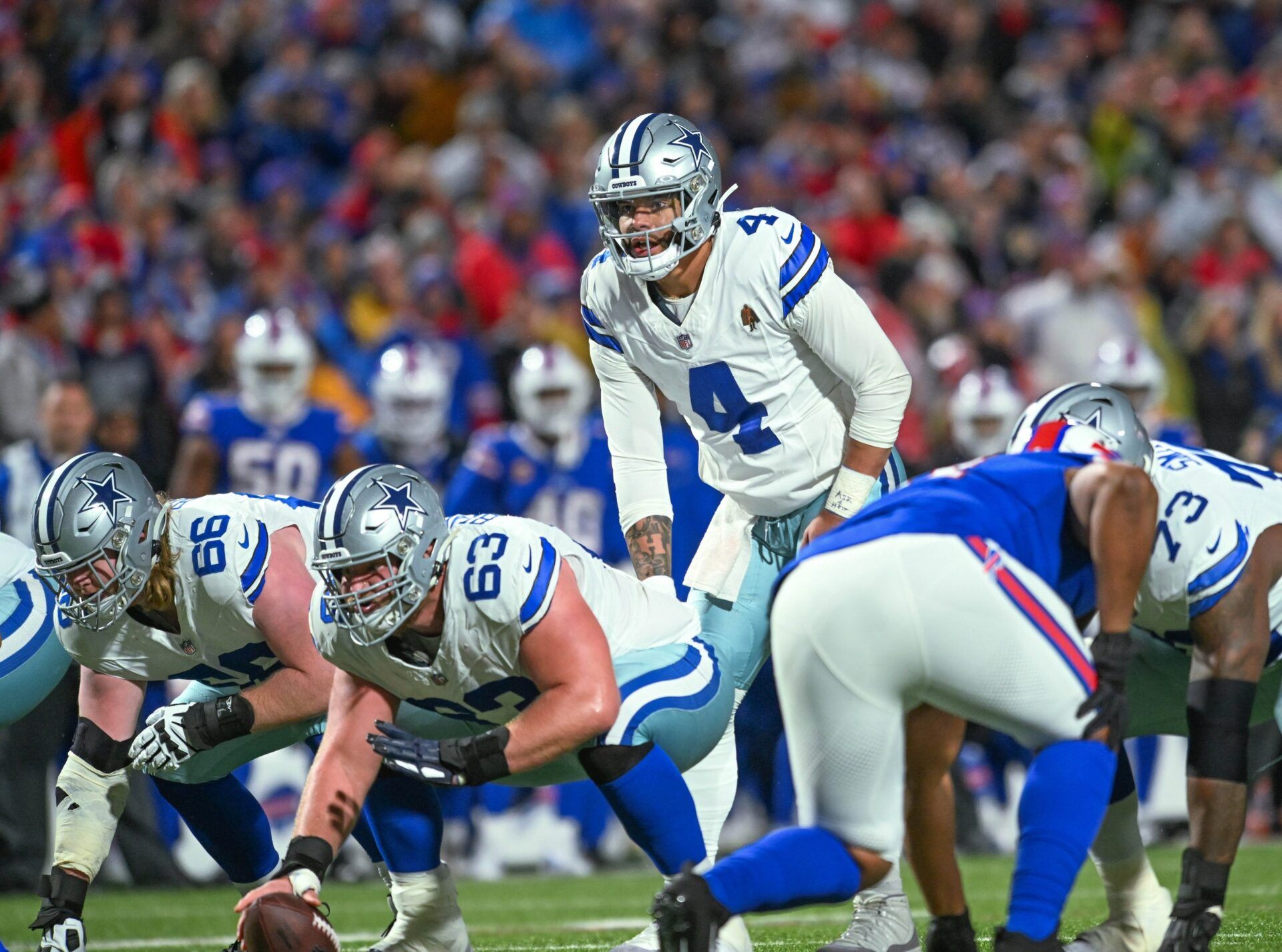 Dallas Cowboys quarterback Dak Prescott (4) and center Tyler Biadasz (63) at the line of scrimmage against the Buffalo Bills in the second quarter at Highmark Stadium.