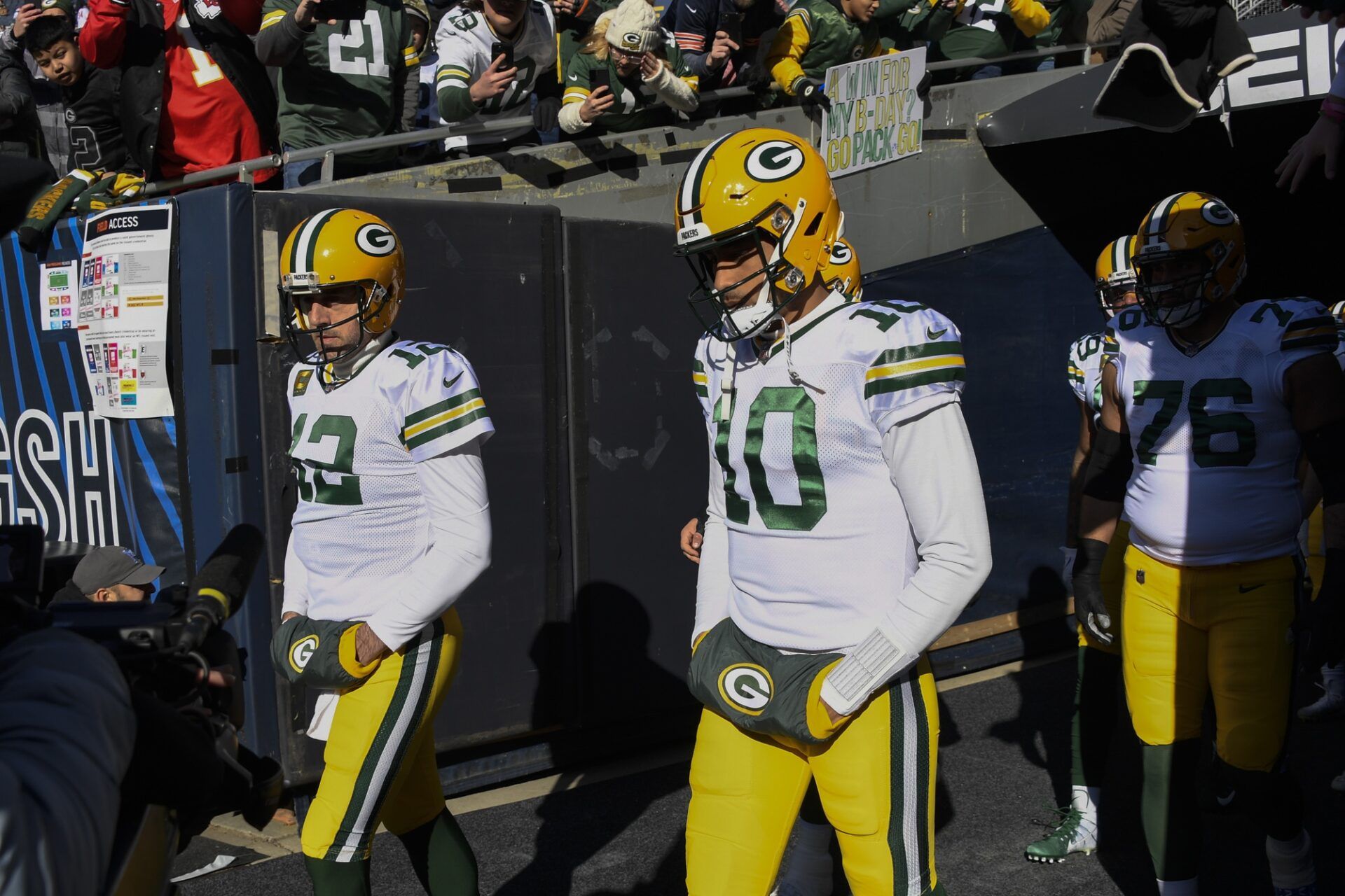 Green Bay Packers quarterbacks Aaron Rodgers (12) and Jordan Love (10) walk out of the tunnel for warmups.