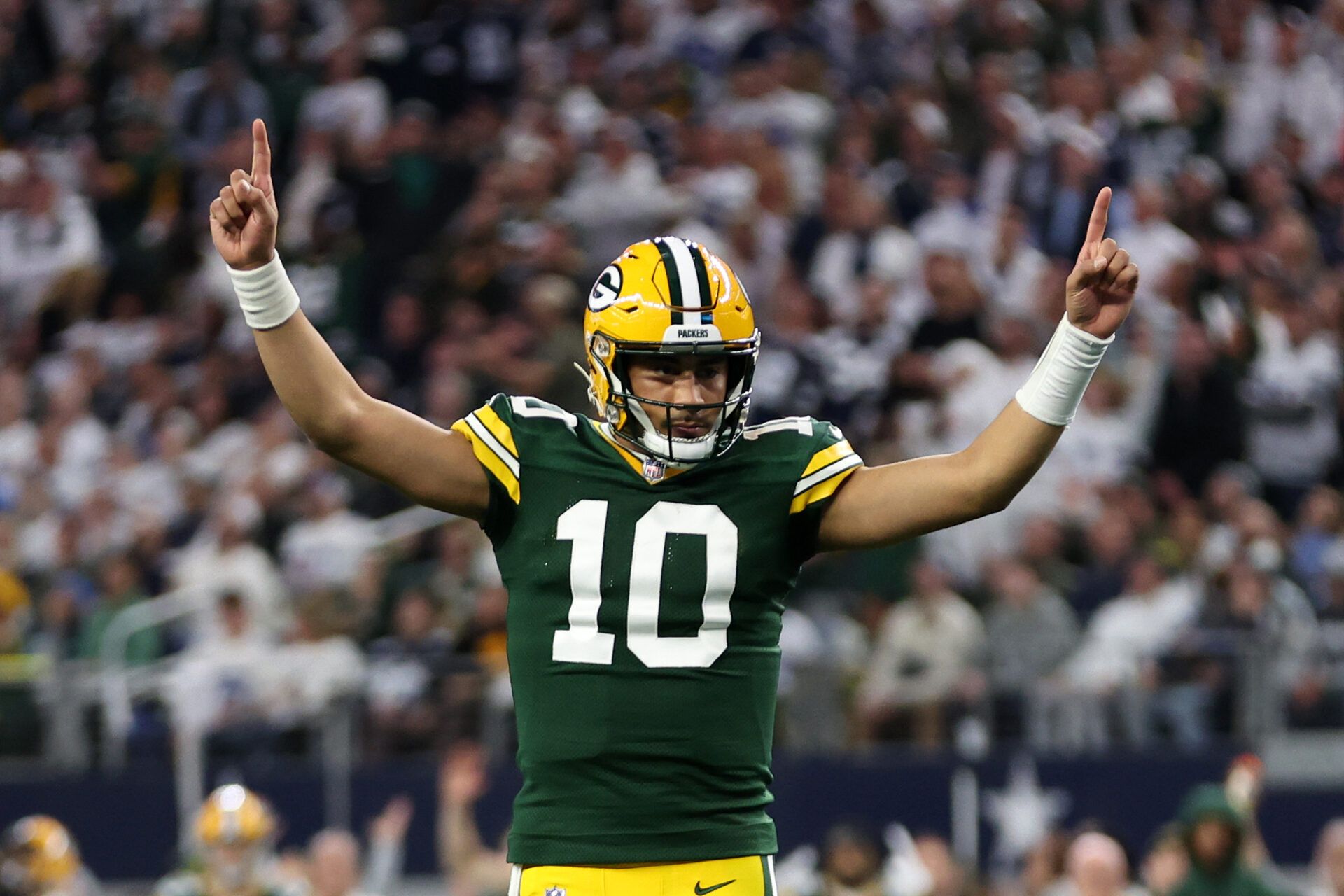 Green Bay Packers quarterback Jordan Love (10) reacts after a touchdown against the Dallas Cowboys in the first quarter for the 2024 NFC wild card game at AT&T Stadium.