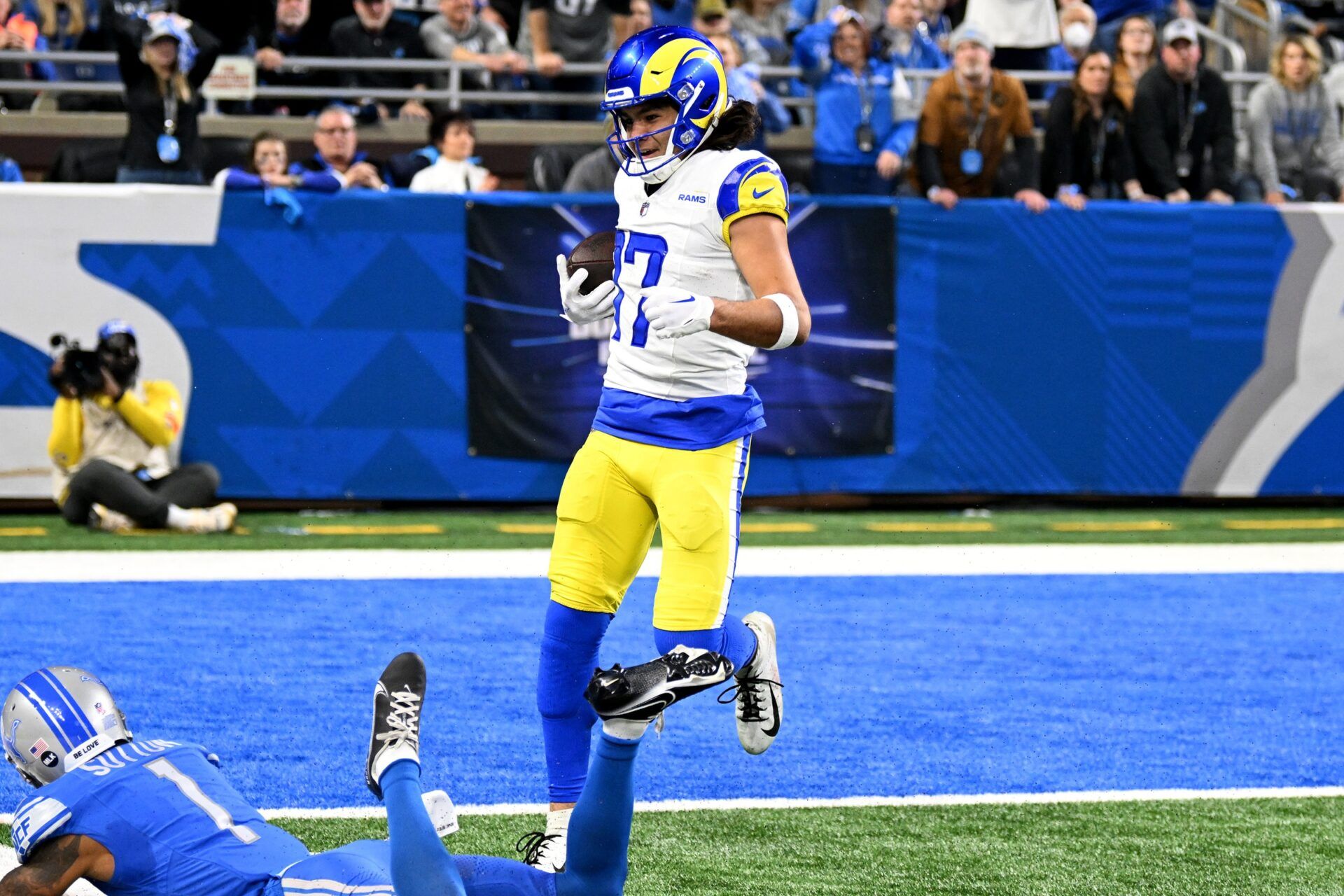 Los Angeles Rams wide receiver Puka Nacua (17) scores a touchdown against Detroit Lions cornerback Cameron Sutton (1) during the first half of a 2024 NFC wild card game at Ford Field.