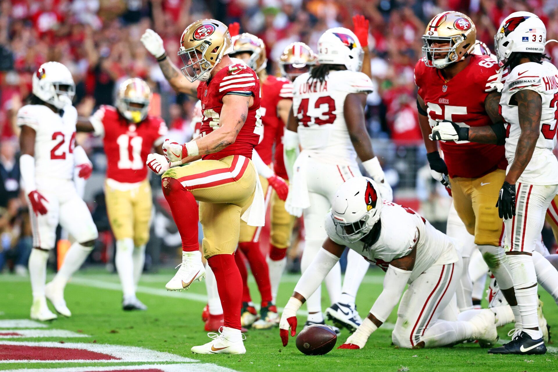 San Francisco 49ers running back Christian McCaffrey (23) celebrates after running for a touchdown during the third quarter against the Arizona Cardinals at State Farm Stadium.