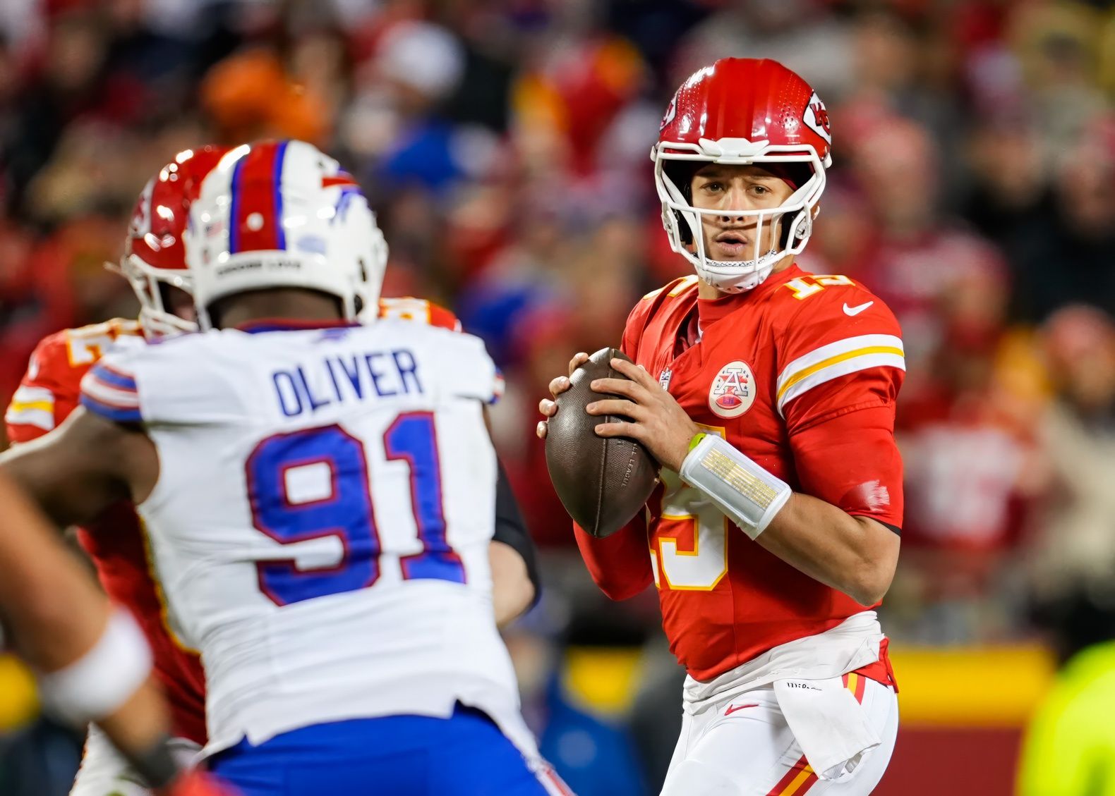 Kansas City Chiefs quarterback Patrick Mahomes (15) against Buffalo Bills defensive tackle Ed Oliver (91) during the second half at GEHA Field at Arrowhead Stadium.