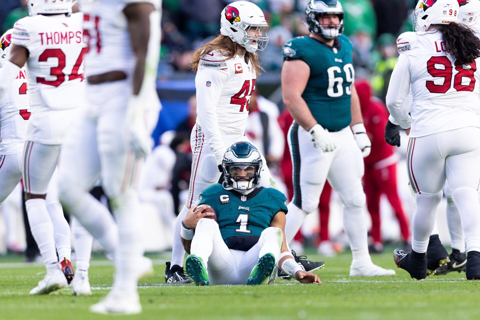 Philadelphia Eagles quarterback Jalen Hurts (1) sits on the field after being tackled during the fourth quarter against the Arizona Cardinals at Lincoln Financial Field.