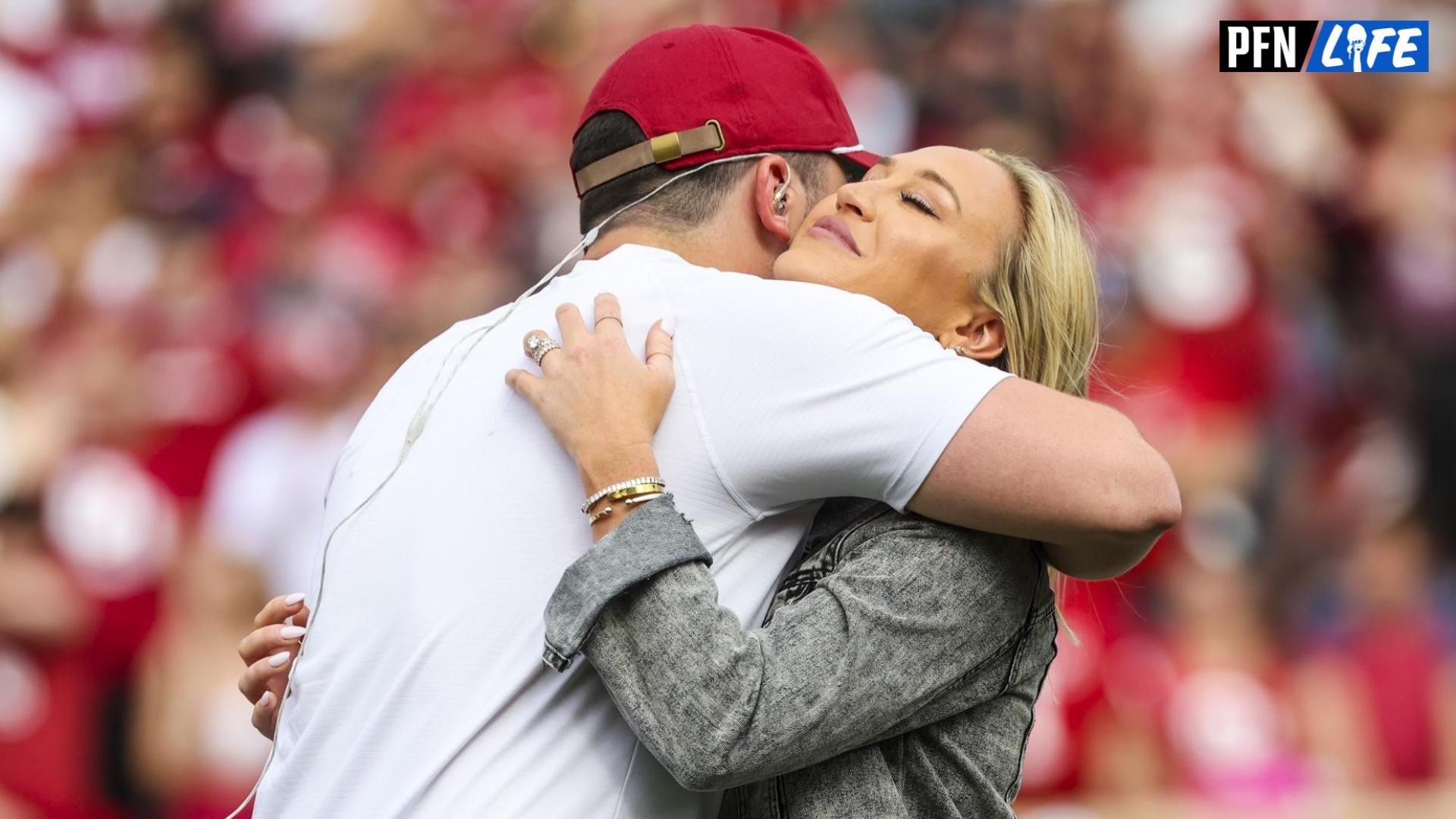 Oklahoma Sooners former player Baker Mayfield hugs his wife Emily as his statue is unveiled during the spring game at Gaylord Family Oklahoma Memorial Stadium.