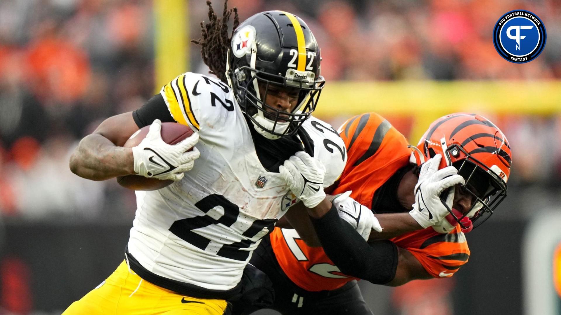 Pittsburgh Steelers running back Najee Harris (22) stiff arms Cincinnati Bengals cornerback Chidobe Awuzie (22) on a carry in the fourth quarter at Paycor Stadium.