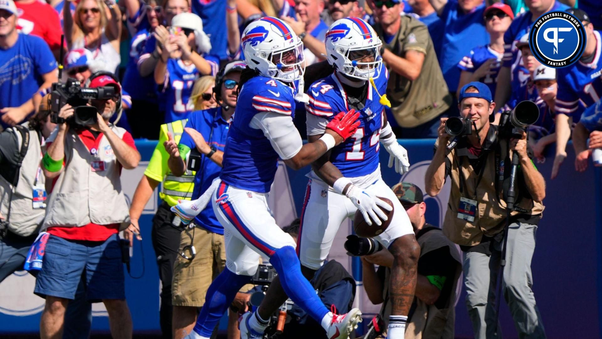 Buffalo Bills running back James Cook (4) congratulates Buffalo Bills wide receiver Stefon Diggs (14) for scoring a touchdown against the Miami Dolphins during the first half at Highmark Stadium.