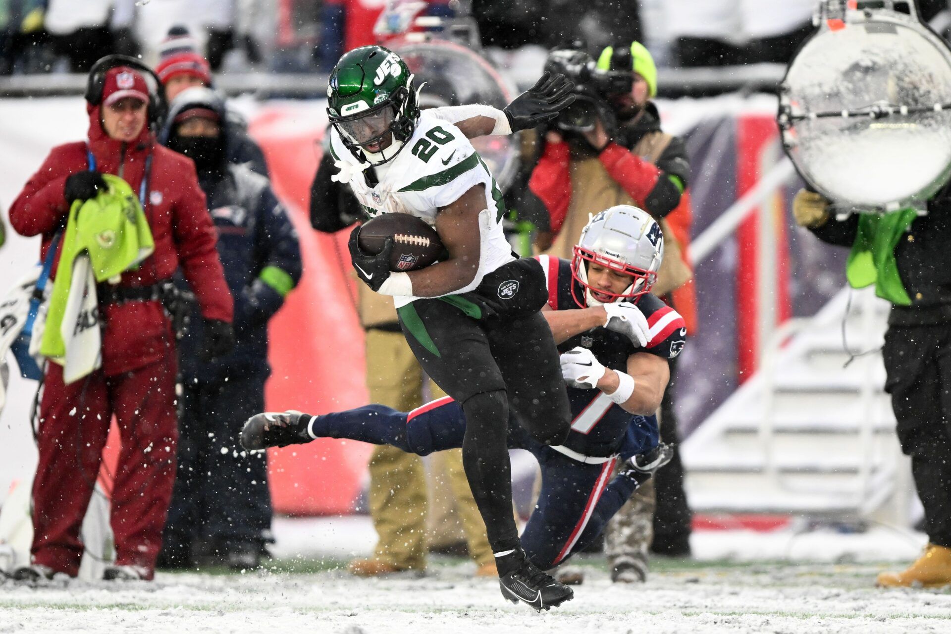 New York Jets running back Breece Hall (20) breaks a tackle by New England Patriots cornerback Myles Bryant (27) during the second half at Gillette Stadium.