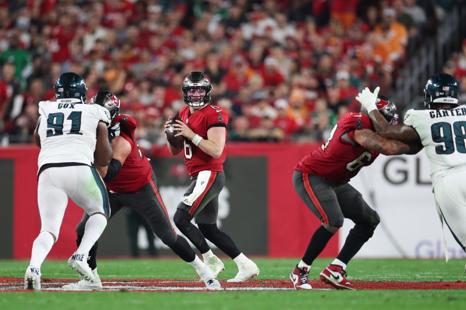 Tampa Bay Buccaneers quarterback Baker Mayfield (6) drops back for a pass against the Philadelphia Eagles during the first half of a 2024 NFC wild card game at Raymond James Stadium.