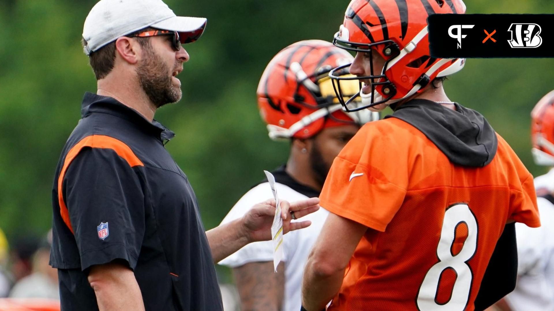 Cincinnati Bengals offensive coordinator (left) talks with QB Brandon Allen (8).