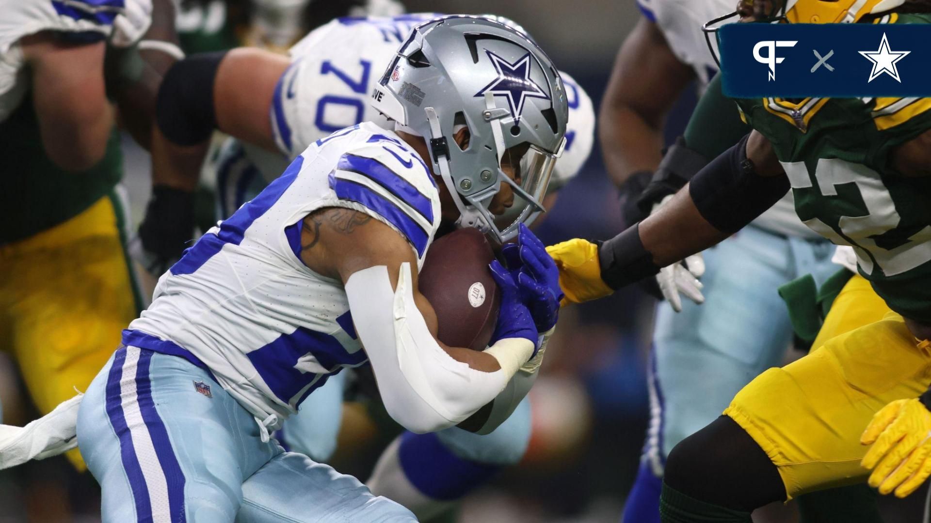 Dallas Cowboys running back Tony Pollard (20) rushes the ball against the Green Bay Packers during the first half for the 2024 NFC wild card game at AT&T Stadium.