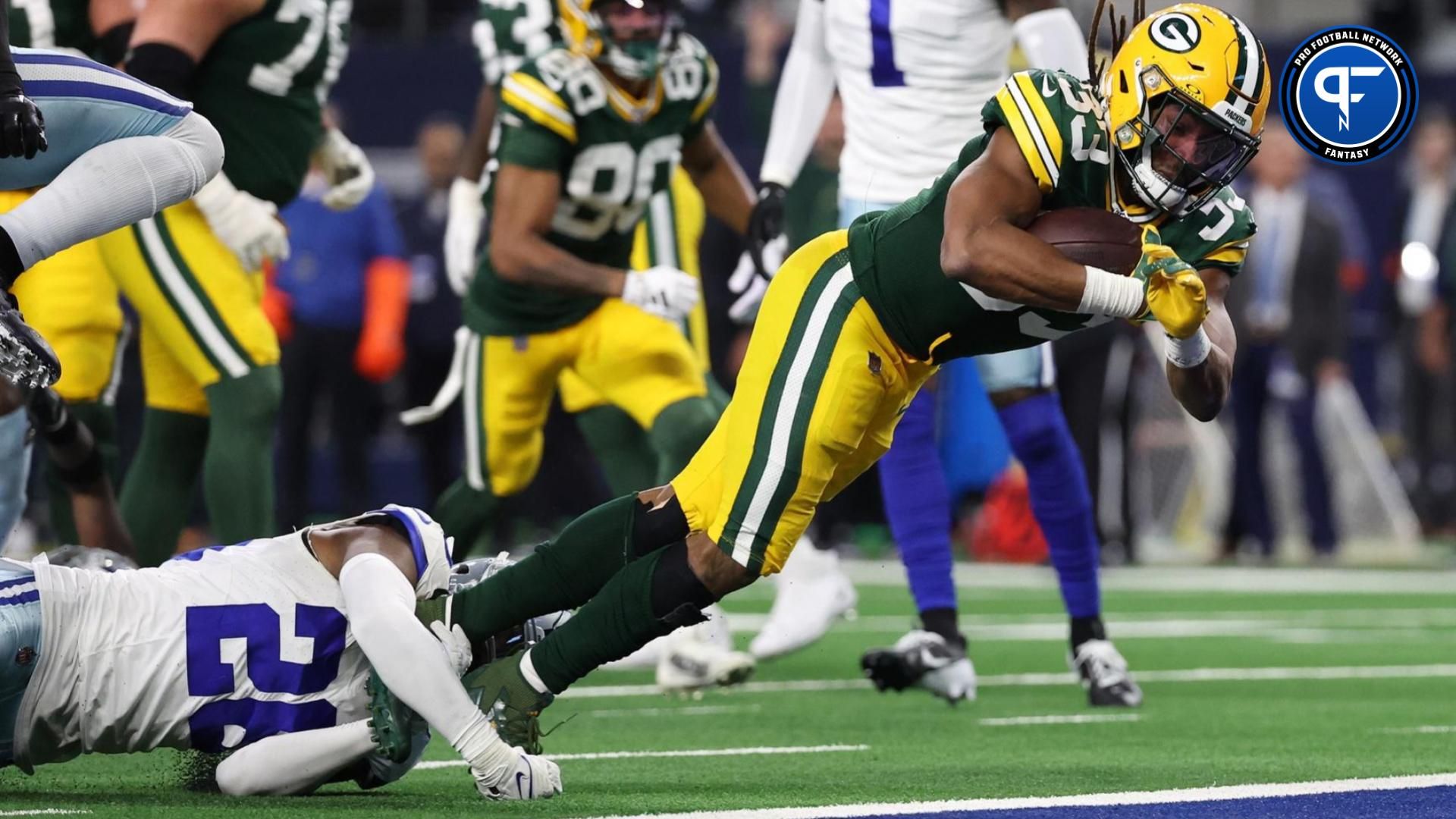 Green Bay Packers running back Aaron Jones (33) rushes the ball for a touchdown against the Dallas Cowboys in the second half for the 2024 NFC wild card game at AT&T Stadium.