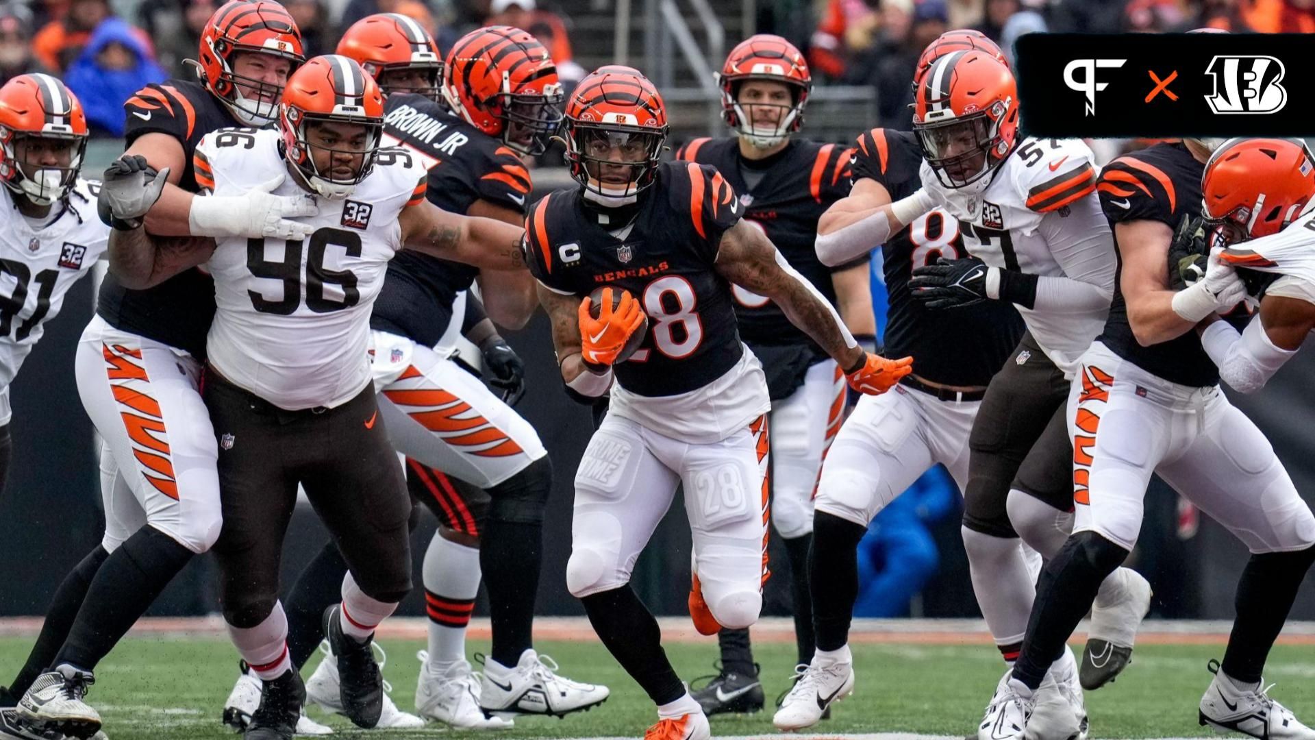 Joe Mixon (28) breaks through the line on a carry in the first quarter of the NFL Week 18 game between the Cincinnati Bengals and the Cleveland Browns at Paycor Stadium.