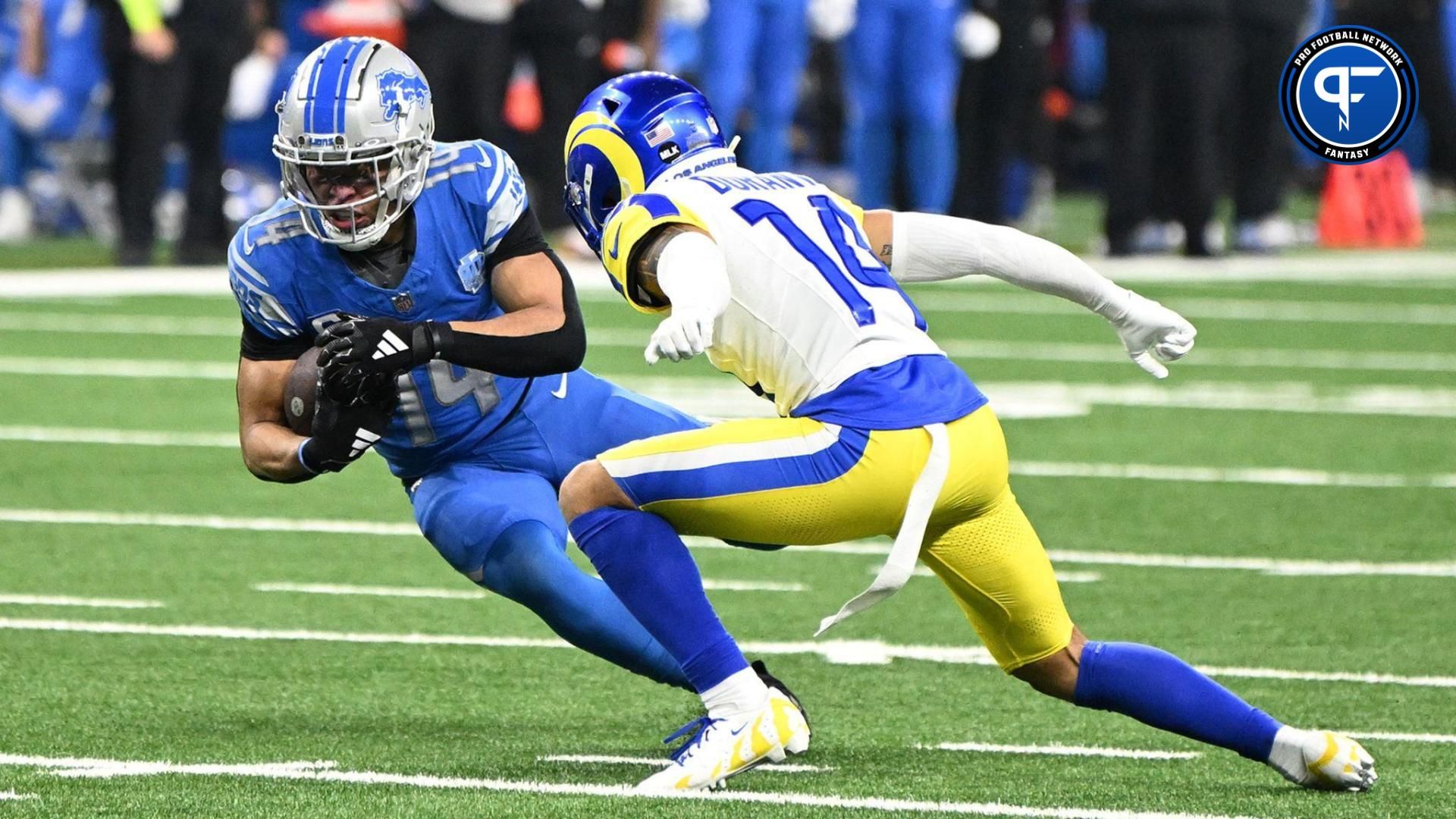 Detroit Lions wide receiver Amon-Ra St. Brown (14) runs against Los Angeles Rams cornerback Cobie Durant (14) during the second half of a 2024 NFC wild card game at Ford Field.