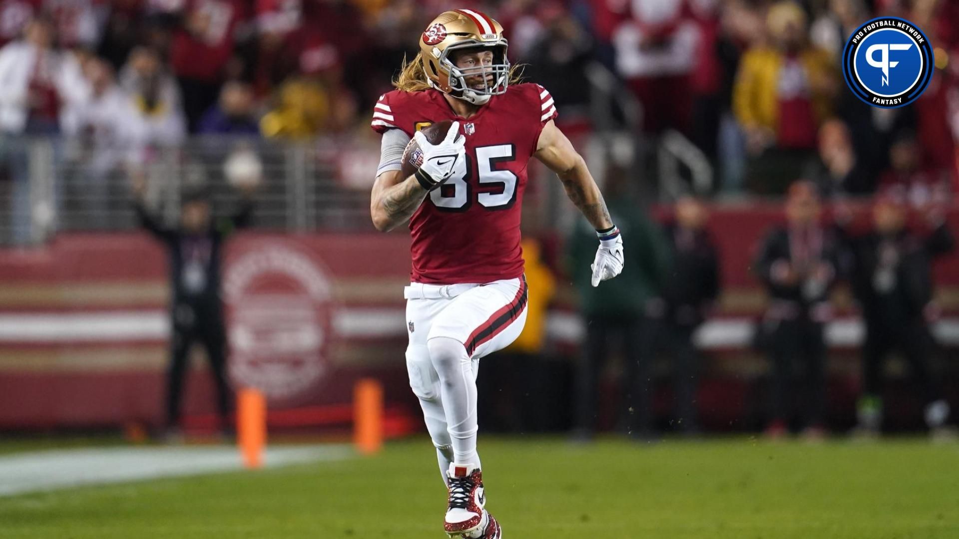 San Francisco 49ers tight end George Kittle (85) runs with the ball after making a catch for a first down against the Baltimore Ravens in the first quarter at Levi's Stadium.