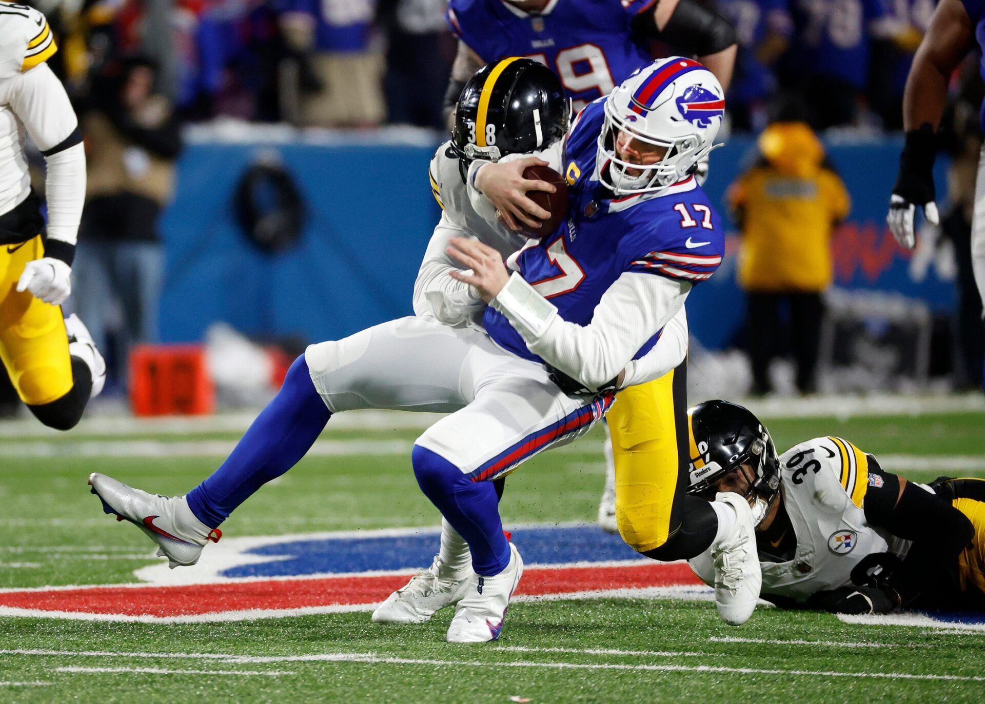 Buffalo Bills quarterback Josh Allen (17) runs for a first down against the Steelers.