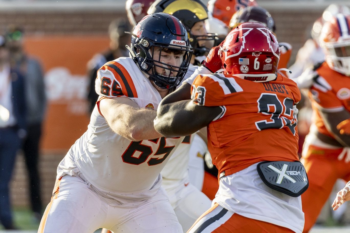 American offensive lineman Nick Broeker of Ole Miss (65) blocks against National defensive lineman Yaya Diaby of Louisville (93) during the second half of the Senior Bowl at Hancock Whitney Stadium.