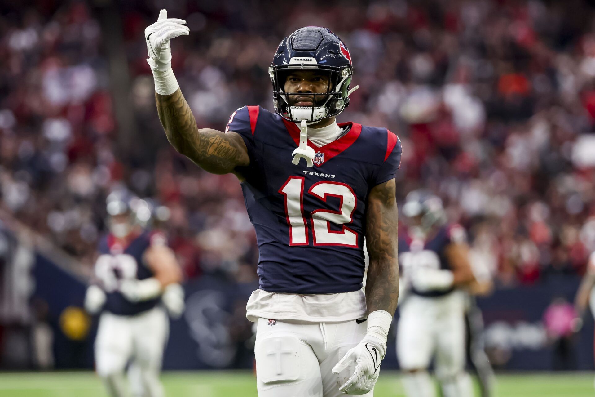 Houston Texans wide receiver Nico Collins (12) celebrates catching the ball during the first quarter in a 2024 AFC wild card game at NRG Stadium.
