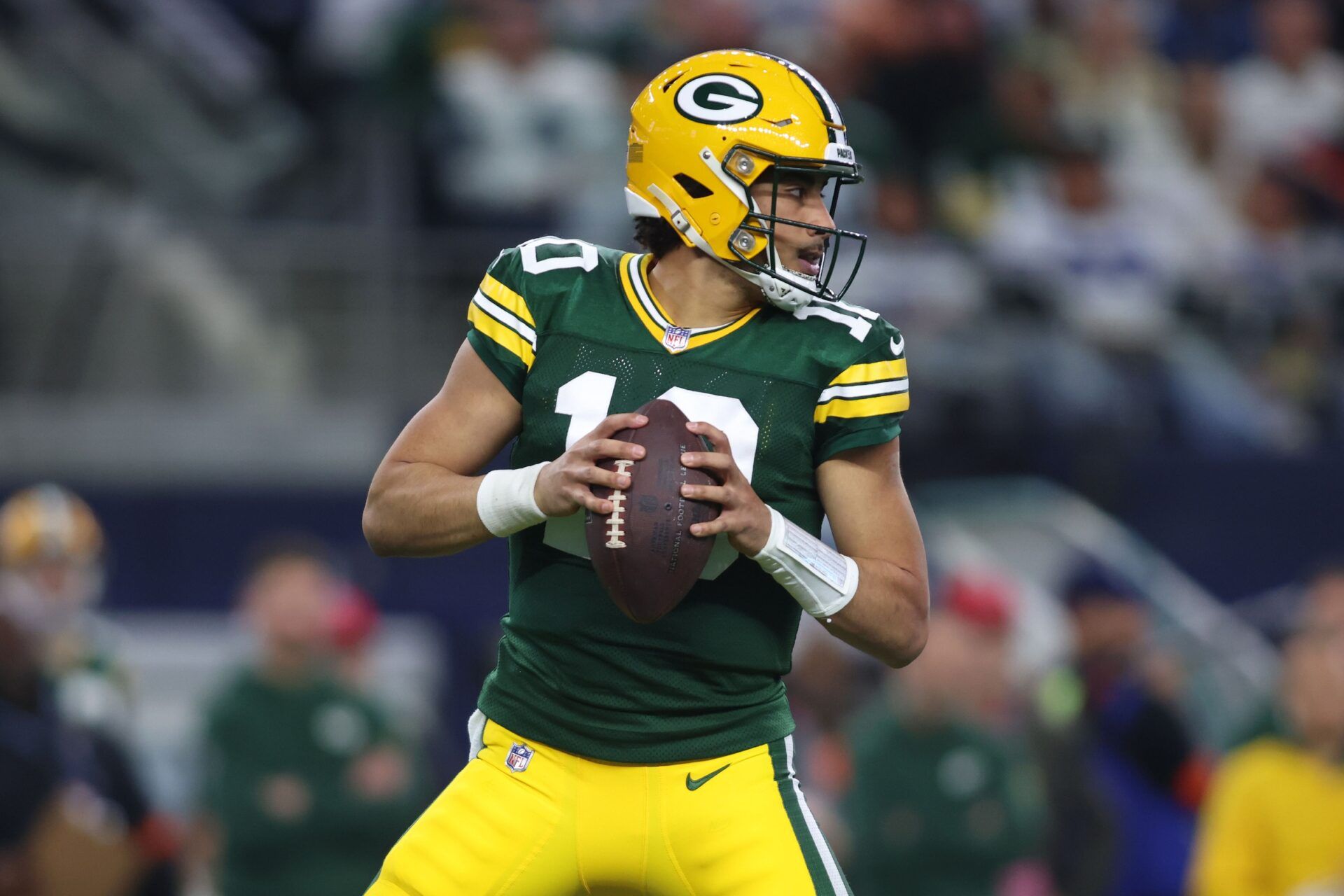 Green Bay Packers quarterback Jordan Love (10) drops back to pass against the Dallas Cowboys in the first quarter for the 2024 NFC wild card game at AT&T Stadium.