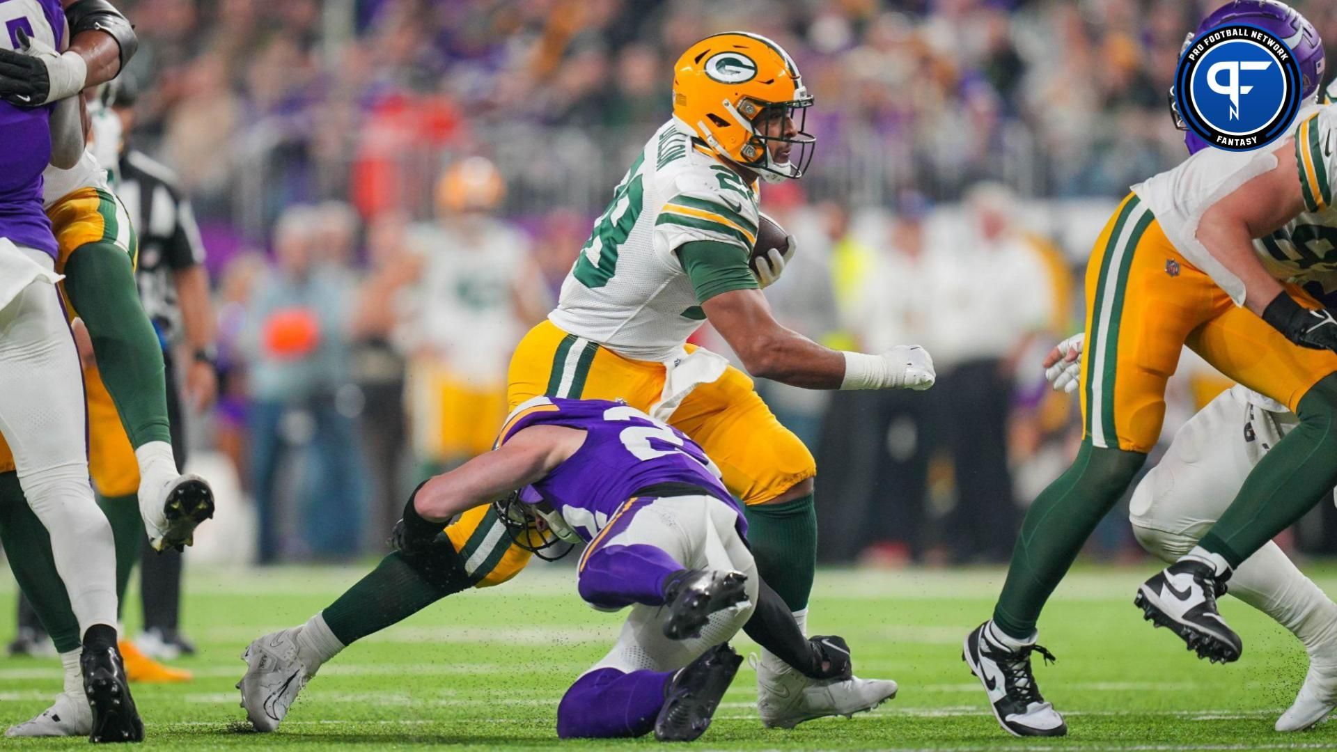 Green Bay Packers running back AJ Dillon (28) runs with the ball against the Minnesota Vikings in the third quarter at U.S. Bank Stadium.