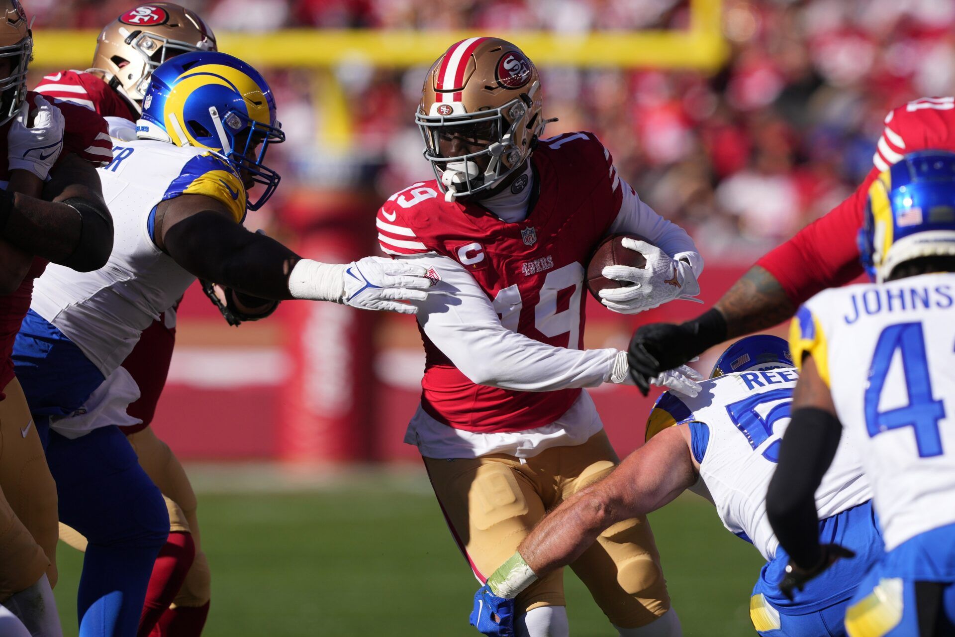 San Francisco 49ers wide receiver Deebo Samuel (19) carries the ball against the Los Angeles Rams during the first quarter at Levi's Stadium.