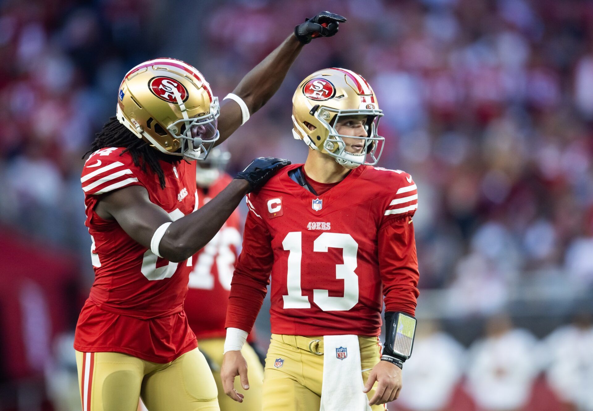 San Francisco 49ers quarterback Brock Purdy (13) celebrates a touchdown with wide receiver Chris Conley (84) against the Arizona Cardinals at State Farm Stadium.