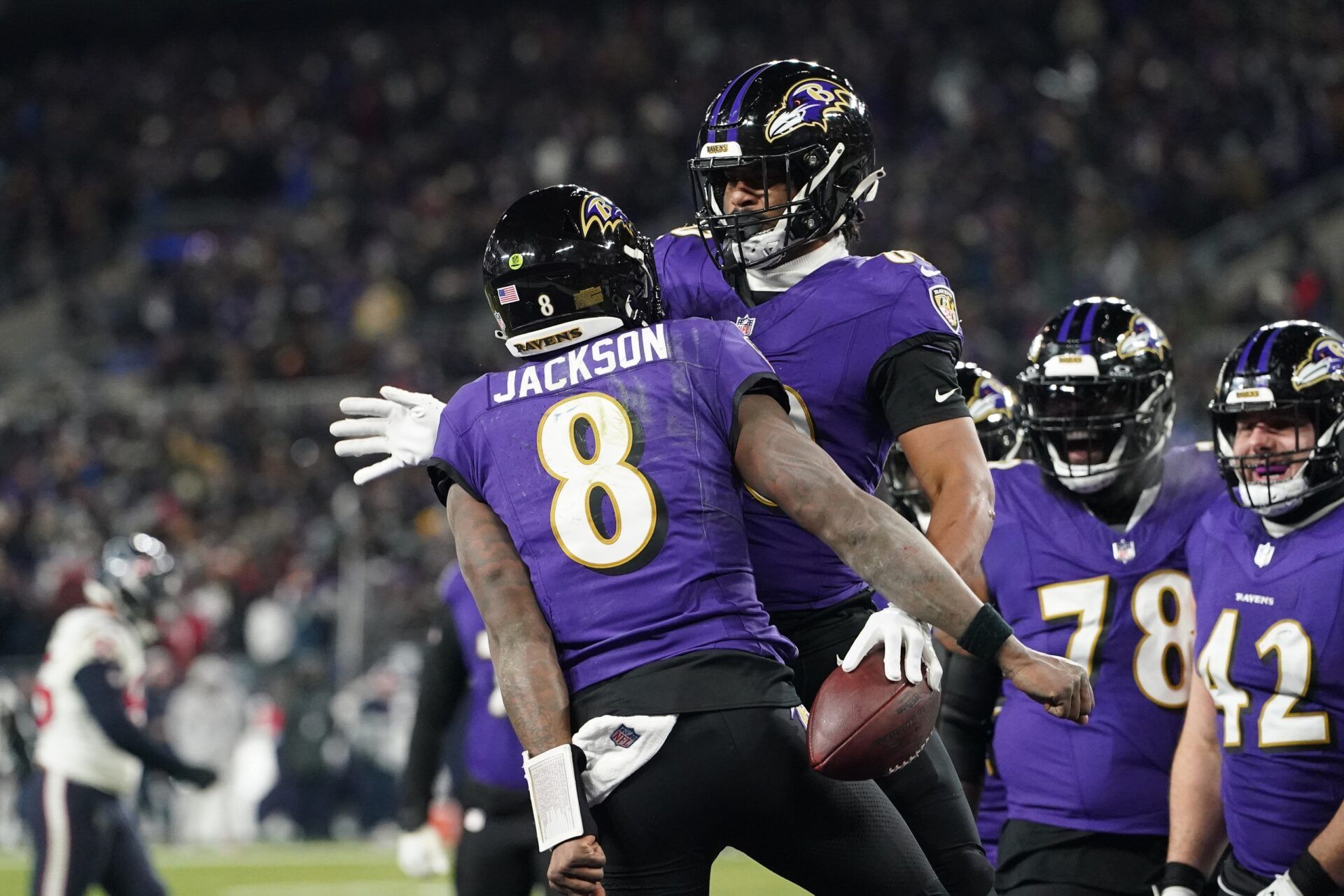 Baltimore Ravens tight end Isaiah Likely (80) celebrates with quarterback Lamar Jackson (8) after catching a pass for a touchdown against the Houston Texans during the fourth quarter of a 2024 AFC divisional round game at M&T Bank Stadium.