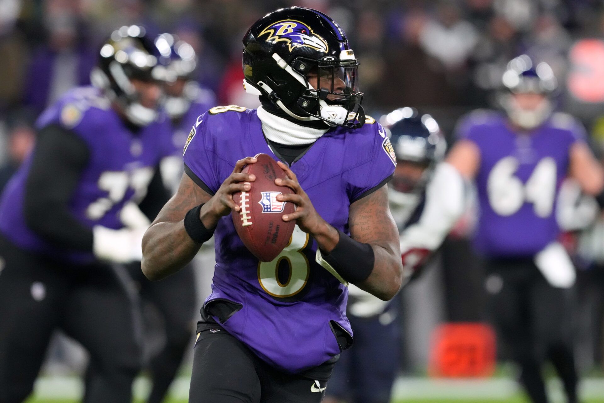 Baltimore Ravens quarterback Lamar Jackson (8) rolls out to throw against the Houston Texans during the second quarter of a 2024 AFC divisional round game at M&T Bank Stadium.