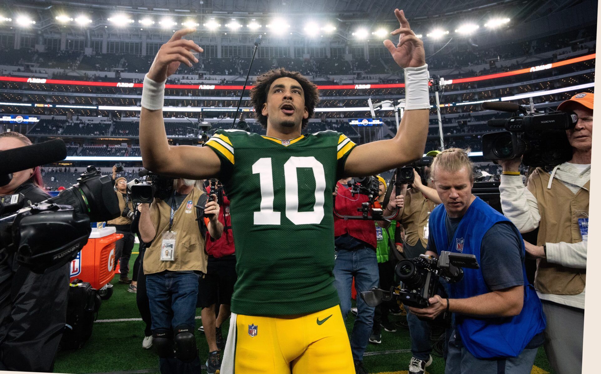 Green Bay Packers QB Jordan Love (10) gestures toward the crowd after the team's Wild Card round win over the Dallas Cowboys.