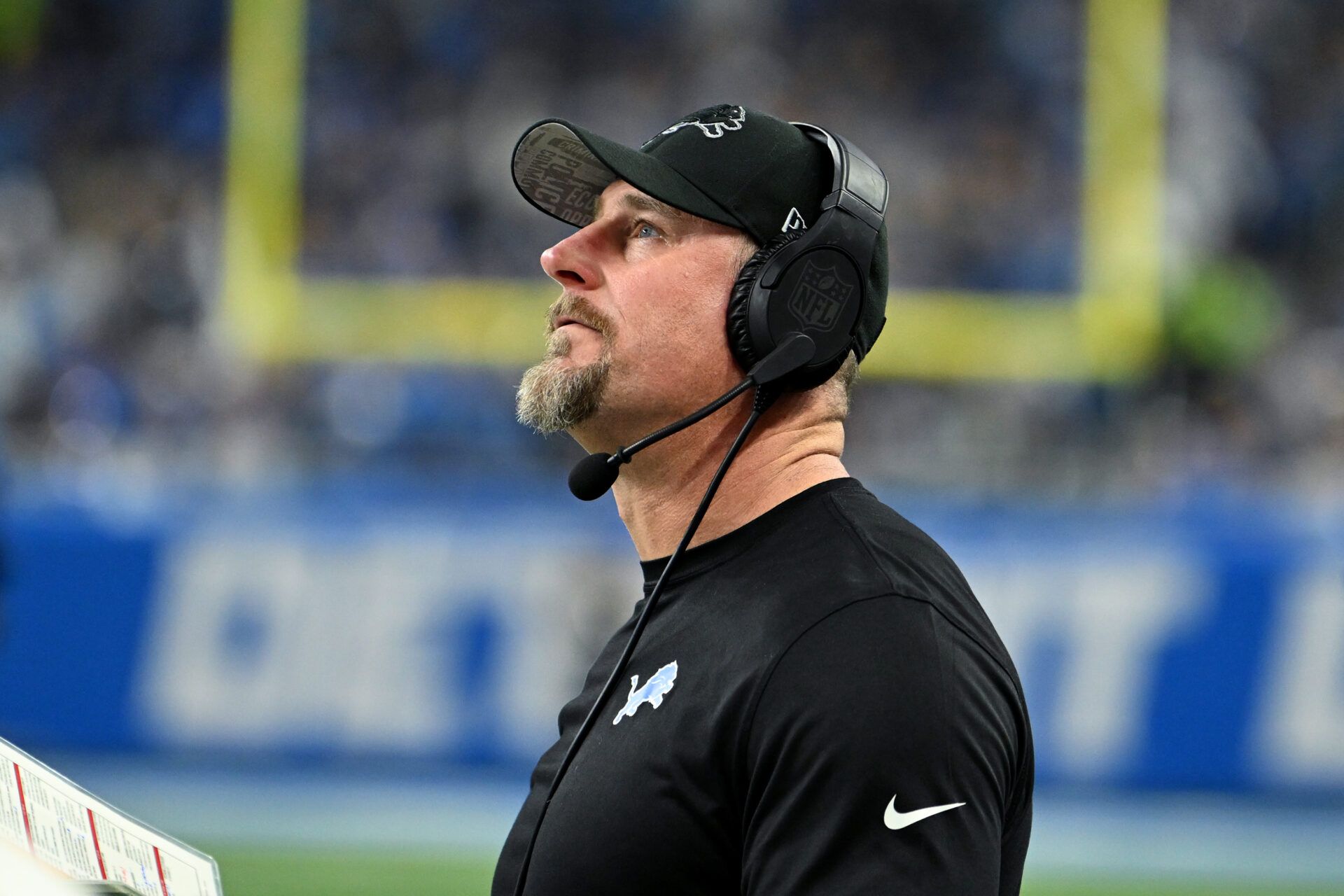 Detroit Lions head coach Dan Campbell looks on against the Tampa Bay Buccaneers during the first half in a 2024 NFC divisional round game at Ford Field.