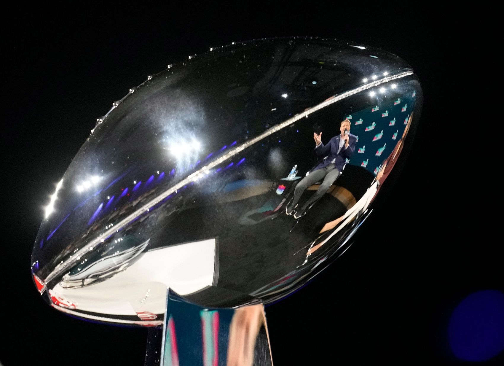 Reflected in the Vince Lombardi Trophy, NFL commissioner Roger Goodell answers a question during a news conference at the Phoenix Convention Center on Feb 8, 2023