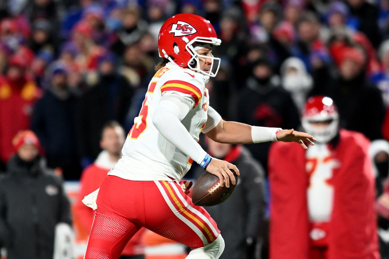 Kansas City Chiefs quarterback Patrick Mahomes (15) rushes the ball against the Buffalo Bills in the first half of the 2024 AFC divisional round game at Highmark Stadium.