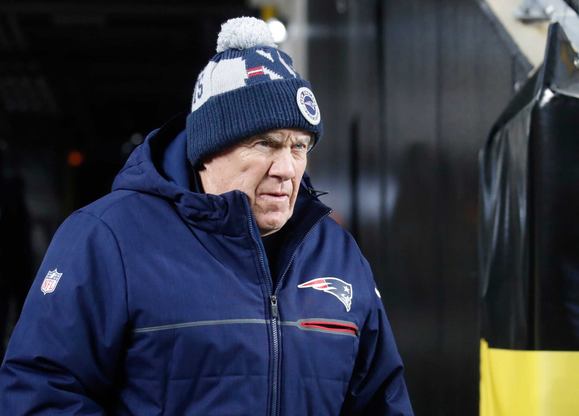 New England Patriots head coach Bill Belichick walks to the field before the game against the Pittsburgh Steelers at Acrisure Stadium.